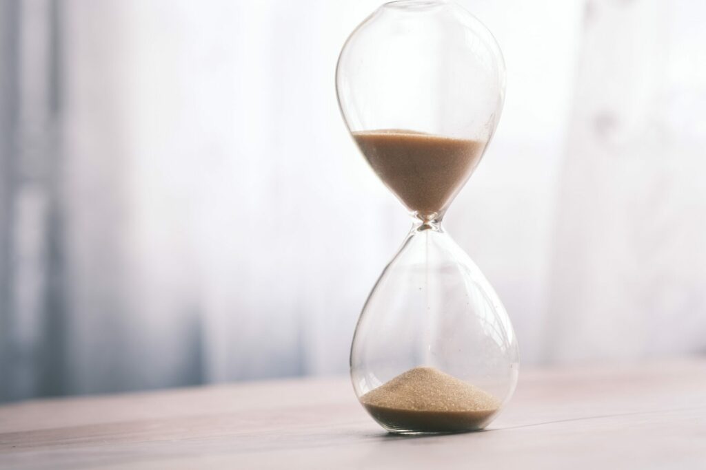 Sand clock as a symbol of time loss waste in construction